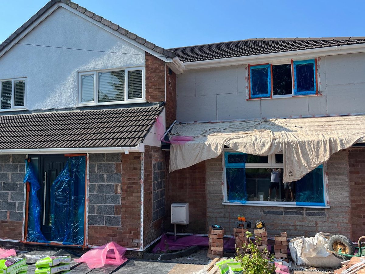 The same house before rendering — bare blockwork, brick and insulation board
