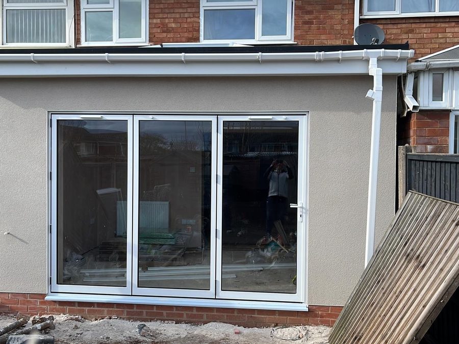 Single-storey rear extension rendered in a smooth grey-cream finish